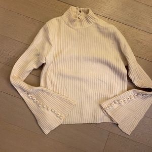 Cream turtleneck sweater with pearl detailing